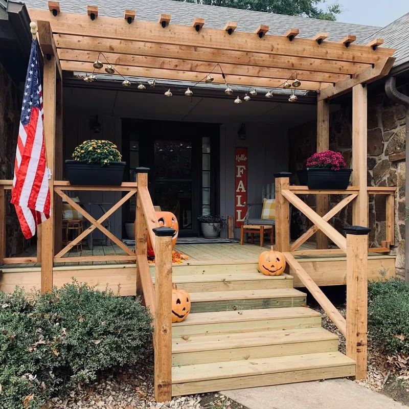 Finished log-home porch with wood rails and steps, C&A Roofing & Construction