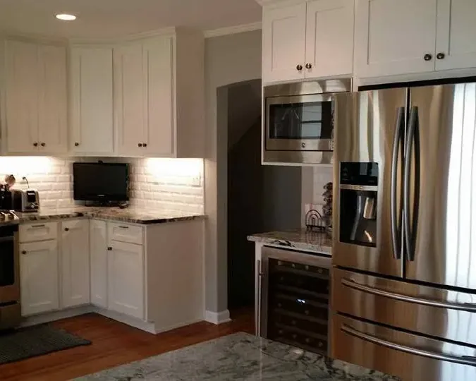White cabinets with stainless range, microwave and fridge, C&A Roofing & Construction