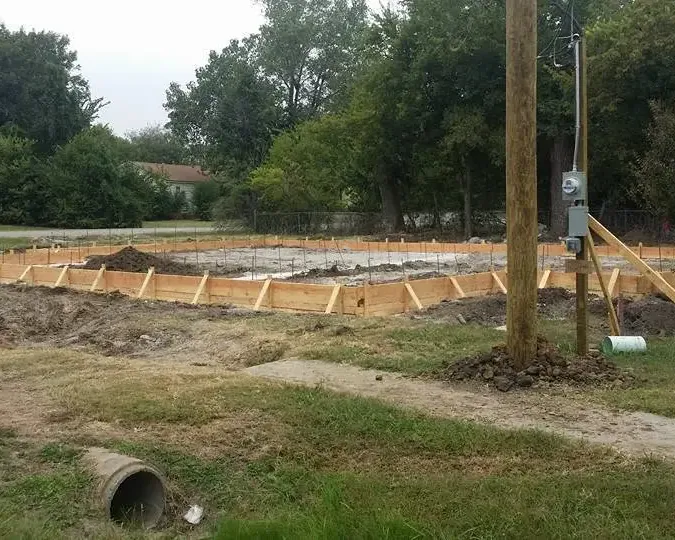 Foundation forms laid out on lot next to utility pole, C&A Roofing & Construction