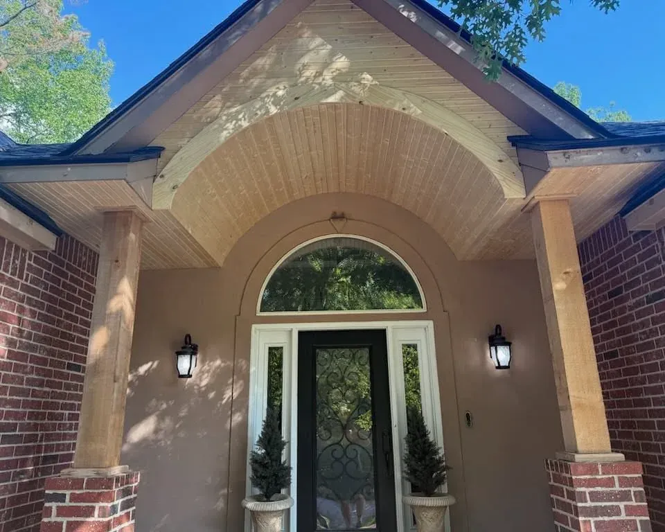 Finished arched front porch entry with wood soffit and columns, C&A Roofing & Construction