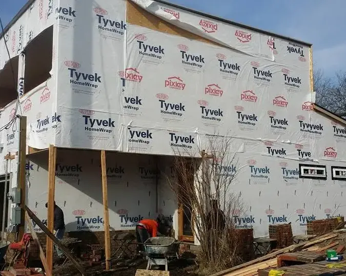 Multi-story house framing wrapped in Tyvek, C&A Roofing & Construction
