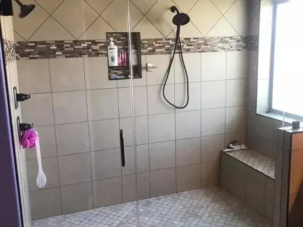 Tiled shower with handheld shower, bench and window, C&A Roofing & Construction