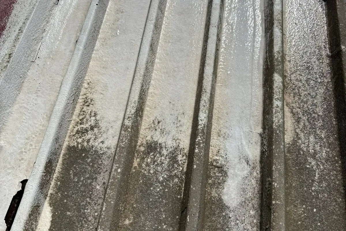 Close-up of dirty corrugated metal roof panels, C&A Roofing & Construction
