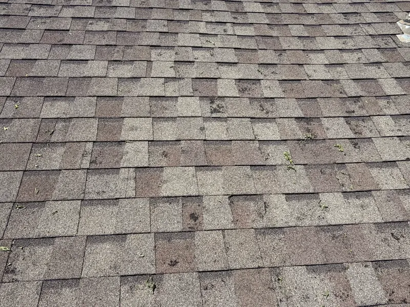 Close-up of worn brown shingles with granule loss, C&A Roofing & Construction