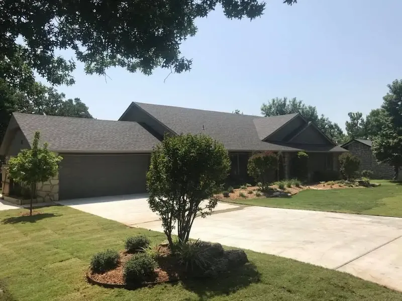 Brick ranch home with shingle roof and long driveway, C&A Roofing & Construction
