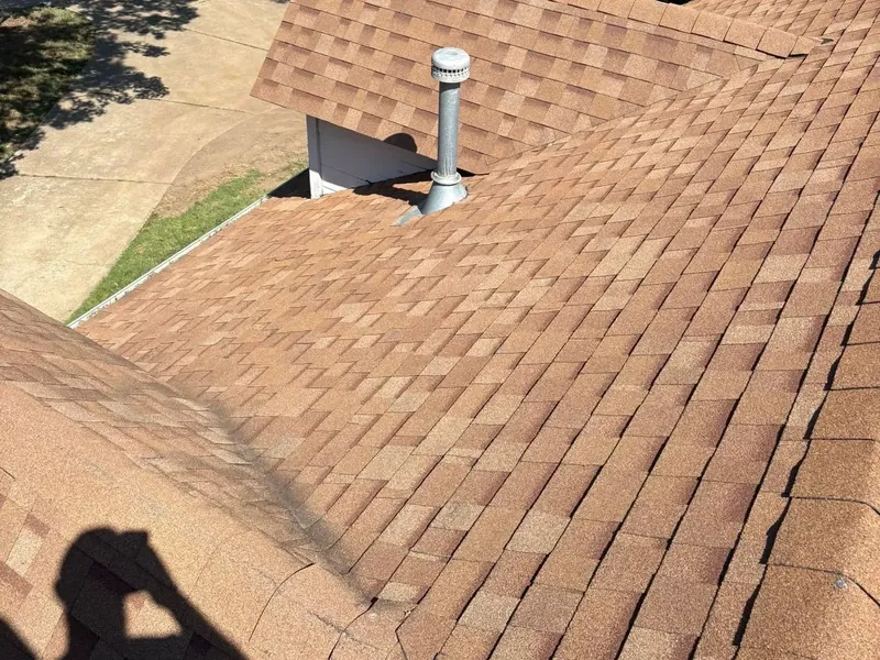 Brown shingle roof slope with pipe vent from rooftop, C&A Roofing & Construction