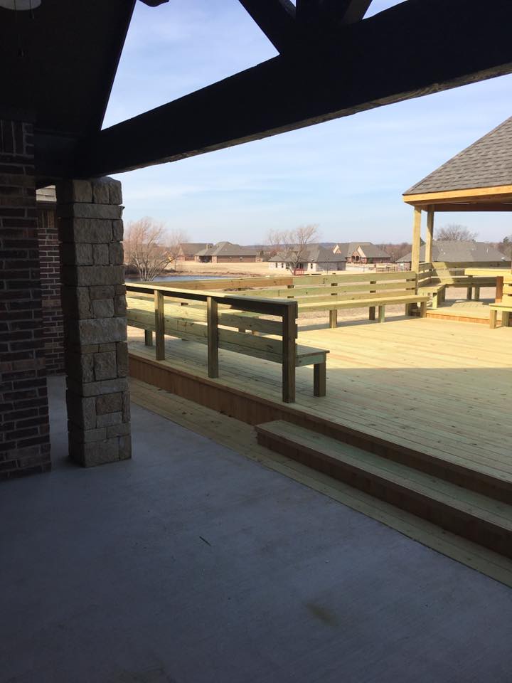 Large deck with built-in seating and railings