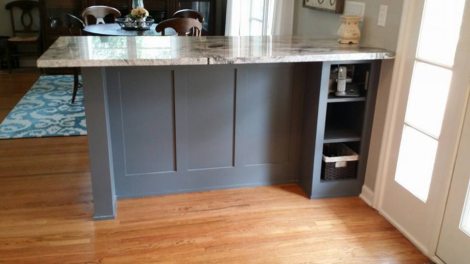 Custom kitchen island with granite countertop and hardwood floors