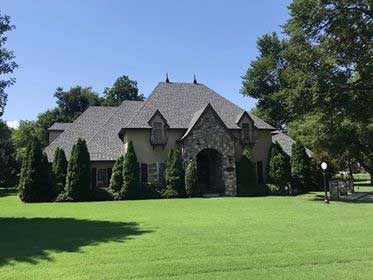 Single-story home with hip roof design showing excellent architectural roofing solutions